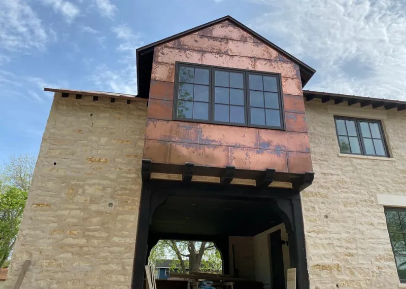 Copper metal panel facade on a stone building for Metal Roof Coating in Baldwin City